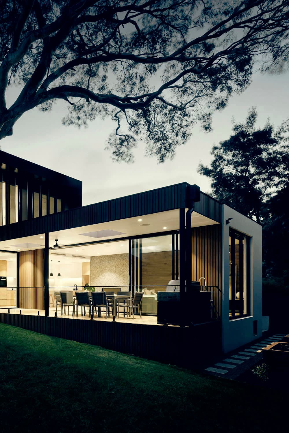 Low pavilion estate under old-growth canopy
